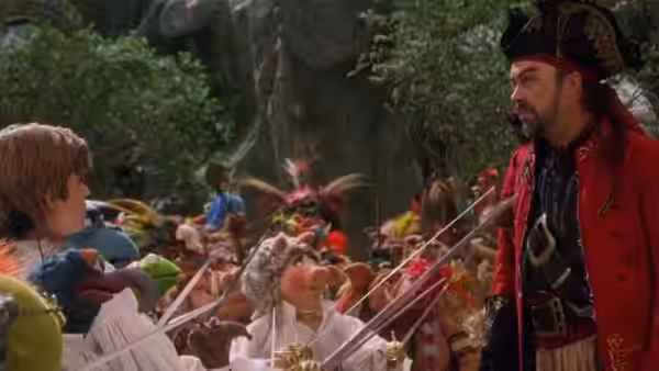 Jim Hawkins facing Long John Silver (Tim Curry) before armed Muppet pirates