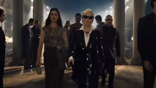 Miranda Priestly (Meryl Streep) walking through a grand colonnade at night with an assistant
