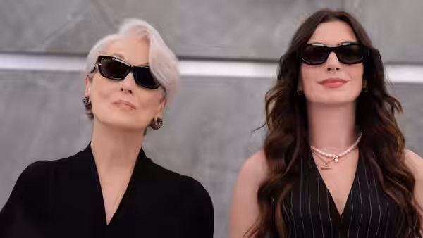 Miranda Priestly (Meryl Streep) and Andy Sachs (Anne Hathaway) standing side by side outdoors