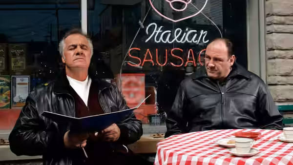 Two men look over a menu at a diner counter
