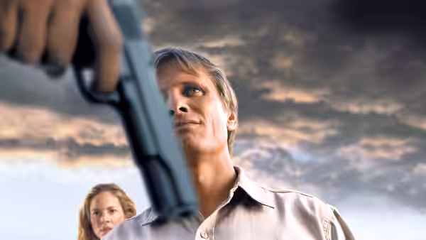 Viggo Mortensen as Tom Stall looking up at a handgun pointed at him