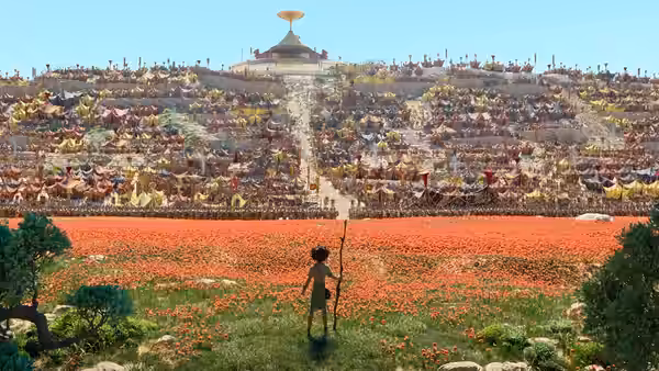 Young boy with staff gazes at vast crowd assembled on red flower hillside