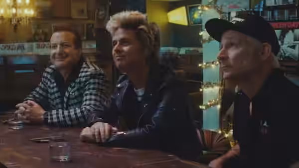 Billie Joe Armstrong and Mike Dirnt at a bar with a man in checkered shirt