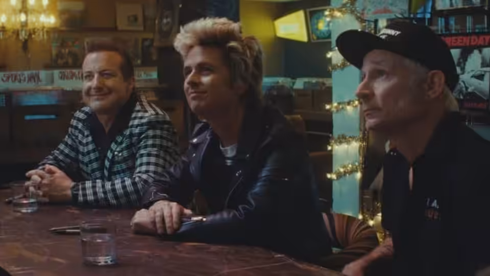 Billie Joe Armstrong and Mike Dirnt at a bar with a man in checkered shirt