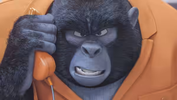 A stern gorilla in an orange coat holding an orange telephone to his ear