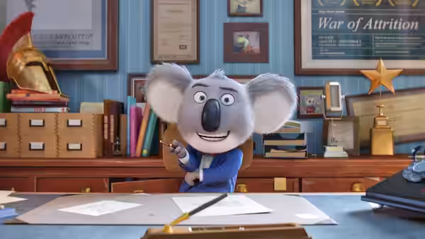 Buster Moon (Matthew McConaughey) gesturing while seated at a desk in an office