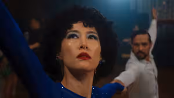 Haru (Rinko Kikuchi) raising her arm while dancing with Fedir