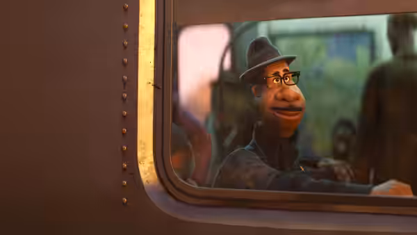 Joe Gardner (Jamie Foxx) looking out from inside a train window