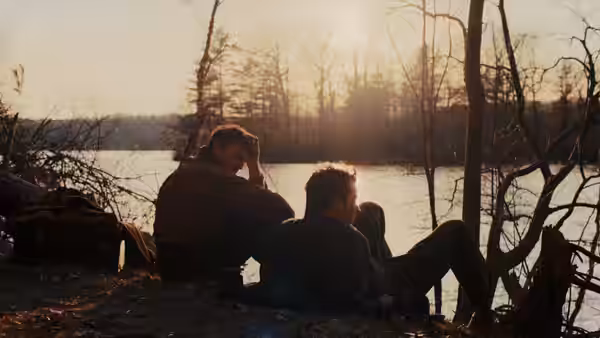 Lionel (Paul Mescal) and David (Josh O'Connor) resting by a sunlit lake