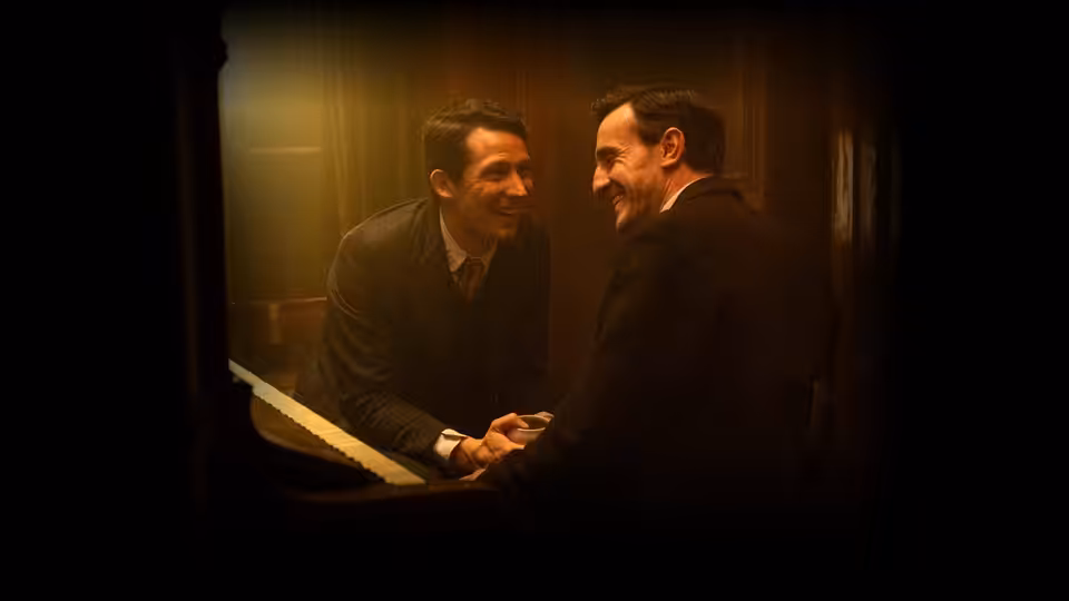 Lionel (Paul Mescal) and David (Josh O'Connor) laughing in a wooden elevator