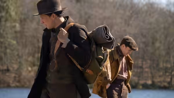 Lionel (Paul Mescal) and David (Josh O'Connor) hiking through bare woods