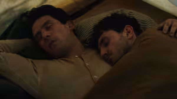 Lionel (Paul Mescal) and David (Josh O'Connor) lying together in bed