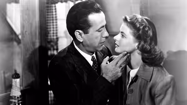 Rick Blaine (Humphrey Bogart) holds Ilsa Lund (Ingrid Bergman) by the chin closely