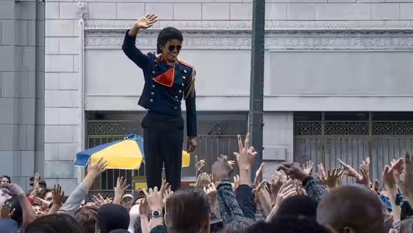 Michael (Jaafar Jackson) waving from above a reaching crowd outdoors
