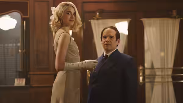 Elizabeth Weiland (Margaret Qualley) touching the arm of Richard Rodgers (Andrew Scott)