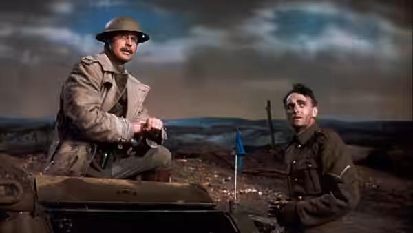 A soldier on a vehicle speaking to another in a barren landscape