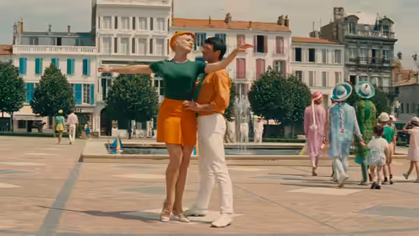 A woman and a man embrace in a town square
