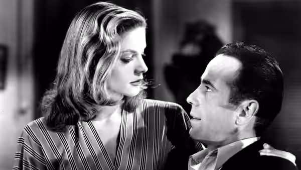 Marie Browning (Lauren Bacall) leans close to Harry Morgan (Humphrey Bogart)