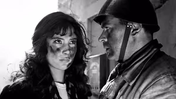 A woman and a helmeted soldier face each other indoors