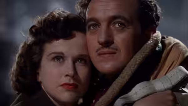 Peter Carter (David Niven) and June (Kim Hunter) embracing each other closely