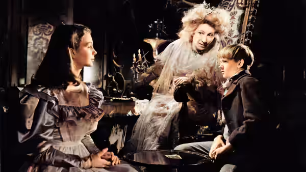 Miss Havisham (Martita Hunt) with Young Estella (Jean Simmons) and Young Pip (Anthony Wager) at a table