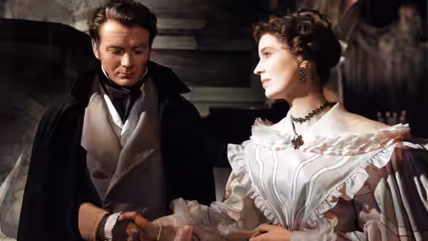 Pip (John Mills) and Estella (Valerie Hobson) facing each other in formal attire