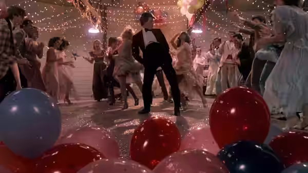 Ren (Kevin Bacon) dancing energetically among balloons at the high school prom