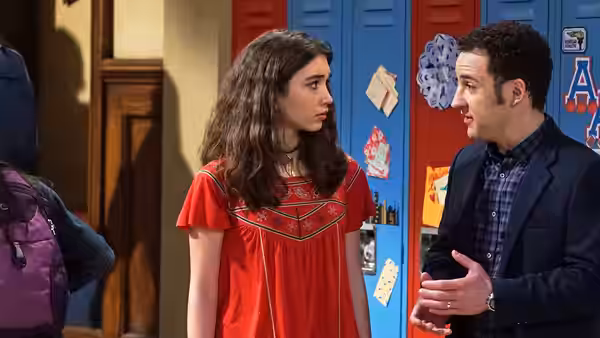 Riley Matthews (Rowan Blanchard) faces a boy speaking by school lockers