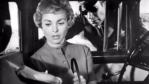 Marion Crane (Janet Leigh) in a car with a policeman looking in