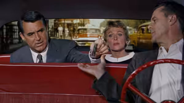 Roger Thornhill (Cary Grant) and Eve Kendall (Eva Marie Saint) in a red convertible