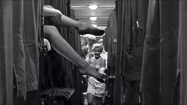 Women in nightwear peering from train sleeping car berths