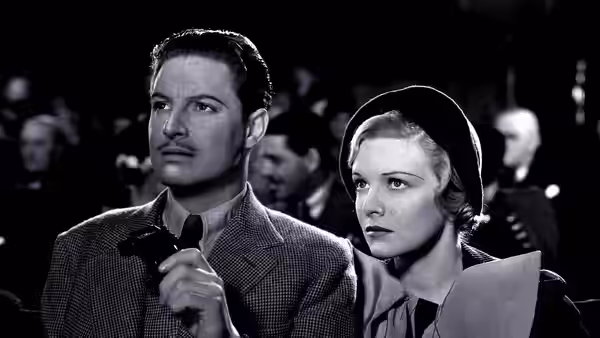 Richard Hannay (Robert Donat) and Pamela (Madeleine Carroll) in a theater audience