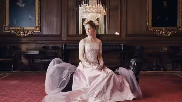 Alma Elson (Vicky Krieps) seated on the floor in an elegant room