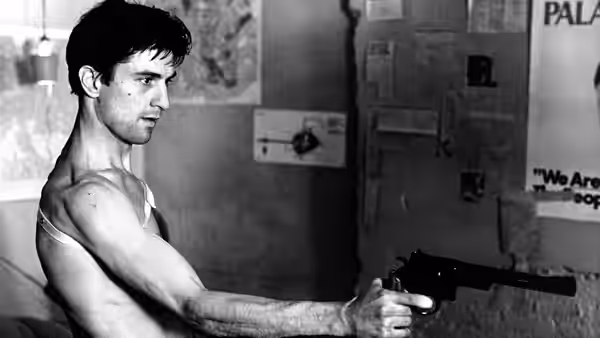 Travis Bickle (Robert De Niro) aiming a revolver while shirtless indoors