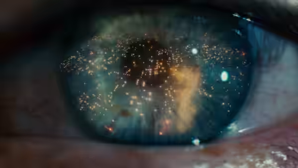 human eye with reflections of city lights and structures in the pupil