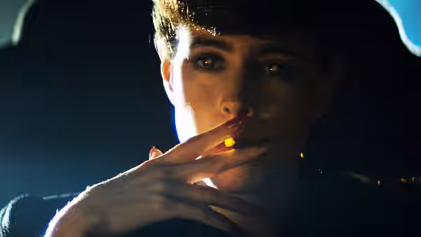 Rachael (Sean Young) holding a lit cigarette to her lips