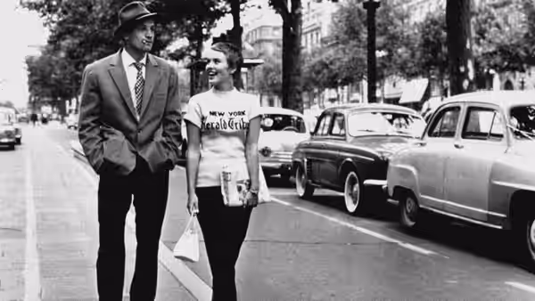 Michel (Jean-Paul Belmondo) and Patricia (Jean Seberg) stand on a Paris sidewalk