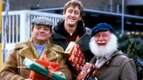 Del Boy (David Jason) Rodney (Nicholas Lyndhurst) and Uncle Albert (Buster Merryfield) hold wrapped presents outdoors