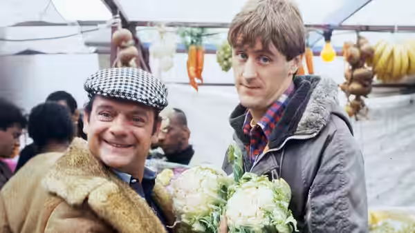 Del Boy (David Jason) and Rodney (Nicholas Lyndhurst) hold cauliflowers at an outdoor market
