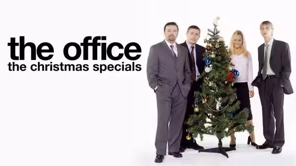 David Brent (Ricky Gervais) and colleagues posing with a Christmas tree