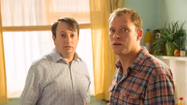 Mark Corrigan (David Mitchell) and Jeremy Usborne (Robert Webb) looking surprised indoors