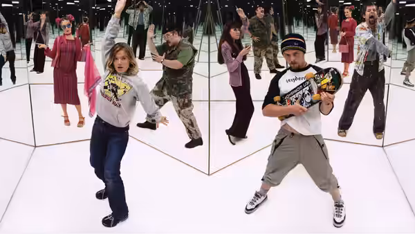 Tim Bisley (Simon Pegg) dancing with a guitar in a mirrored room