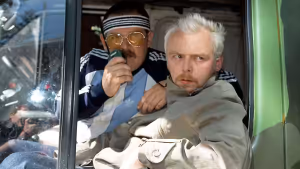 Tim Bisley (Simon Pegg) in a van with a man holding a radio