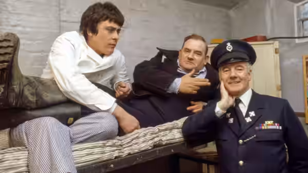 Godber (Richard Beckinsale) and Fletcher (Ronnie Barker) with a prison officer on the bunks