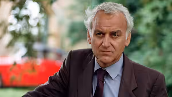 Chief Inspector Morse (John Thaw) looks ahead in a close-up outdoor portrait