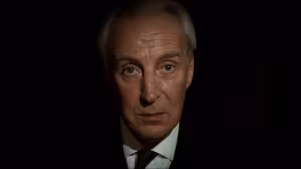 Francis Urquhart (Ian Richardson) in close-up against a dark background