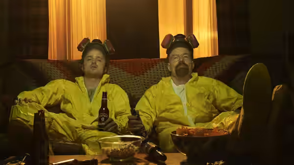 Jesse Pinkman (Aaron Paul) and Walter White (Bryan Cranston) relaxing in hazmat suits on a couch