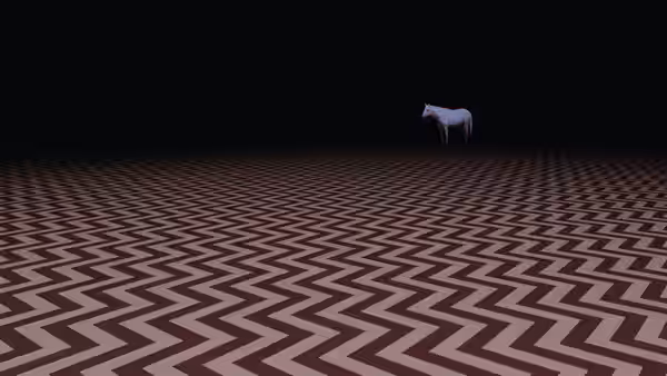 White horse standing on a brown and white zigzag floor in a dark space