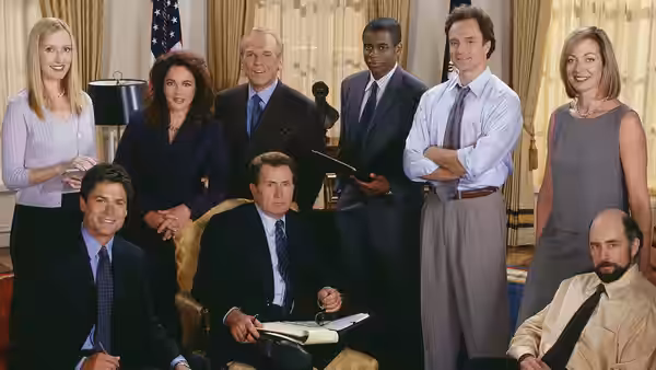 Josiah Bartlet (Martin Sheen) seated with staff in the Oval Office