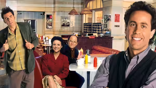 Cosmo Kramer gives thumbs up while Elaine Benes George Costanza and Jerry Seinfeld sit in a cafe